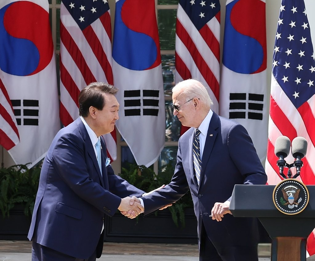 South Korean President Yoon Suk Yeol (left) shakes hands with US President Joe Biden during a joint news conference after their summit at the White House in Washington, DC, on last Wednesday (Yonhap)