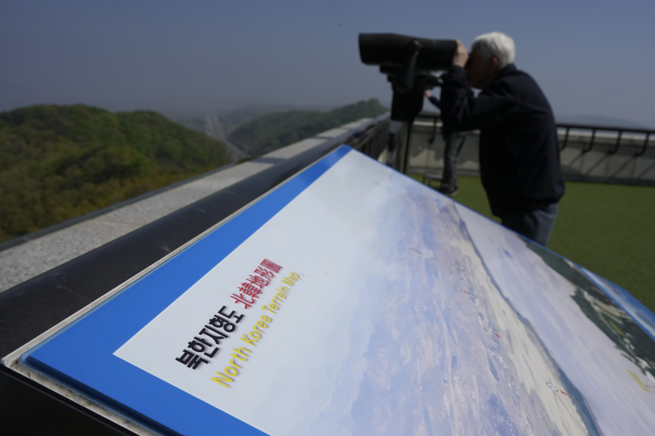 A visitor uses binoculars to see the North Korean side from the unification observatory in Paju, South Korea, on April 19. (AP-Yonhap)
