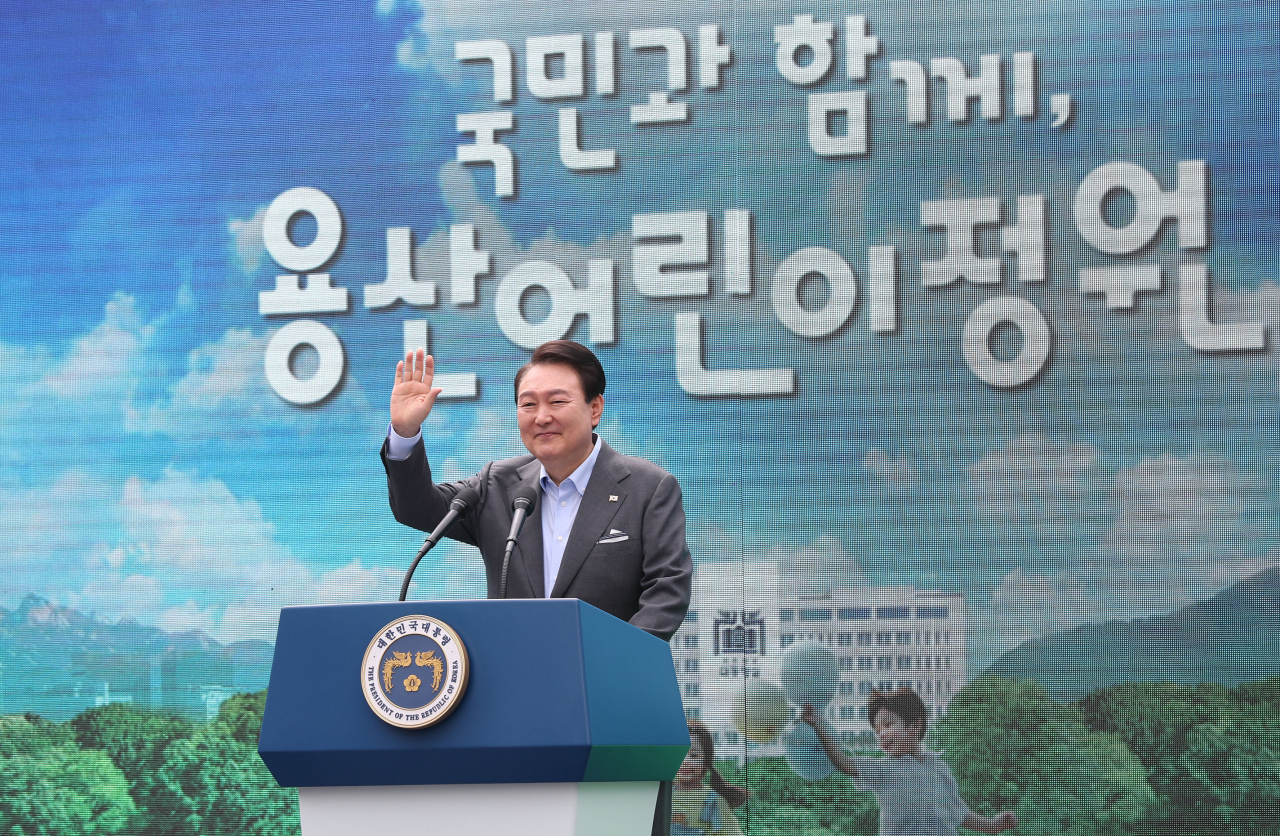 President Yoon Suk Yeol waves during a ceremony at Yongsan Children's Garden in front of the presidential office in Seoul last Thursday.(Yonhap)