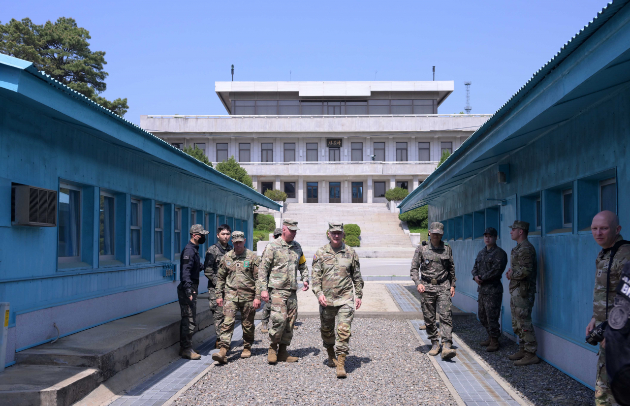 Chief of Staff of the United States Army Gen. James McConville stands next to the low concrete border marker that separates the two Koreas in the Joint Security Area on Tuesday. (Lee Sang-sub/The Korea Herald)