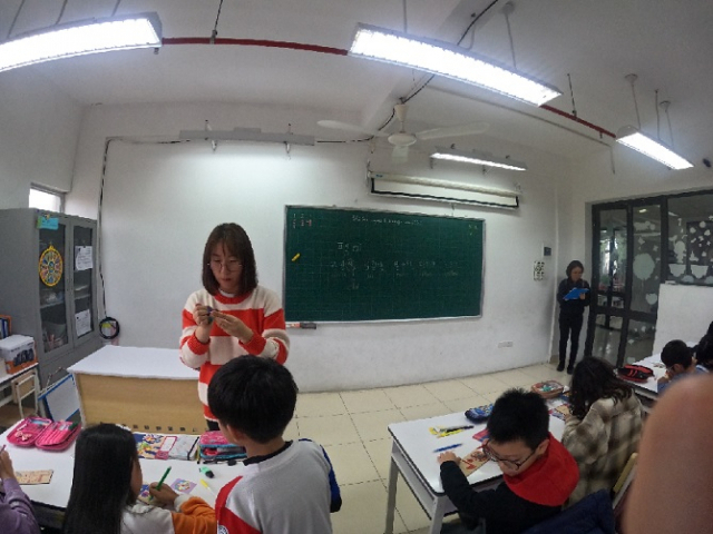 2월 8일 알프레드 노벨 학교의 5학년 대상 한국어 교실에서 선생님과 학생들이 팽이를 만들고 있다.