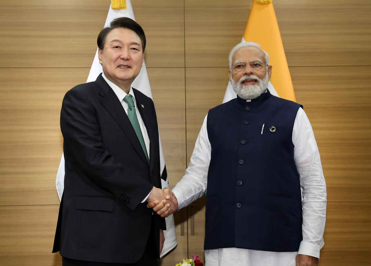 President Yoon Suk Yeol, who visits Japan to attend the G7 summit, shakes hands with Indian Prime Minister Narendra Modi at the Korea-India summit held at a hotel in Hiroshima on Saturday. (Yonhap)