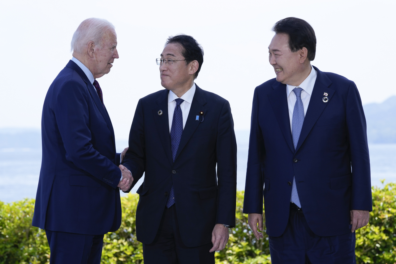 President Yoon Seok Yeol (first from the right), on his visit to Japan, is seen in this photo with US President Joe Biden and Japanese Prime Minister Fumio Kishida ahead of the Korea-US-Japan trilateral summit on Sunday (AP)