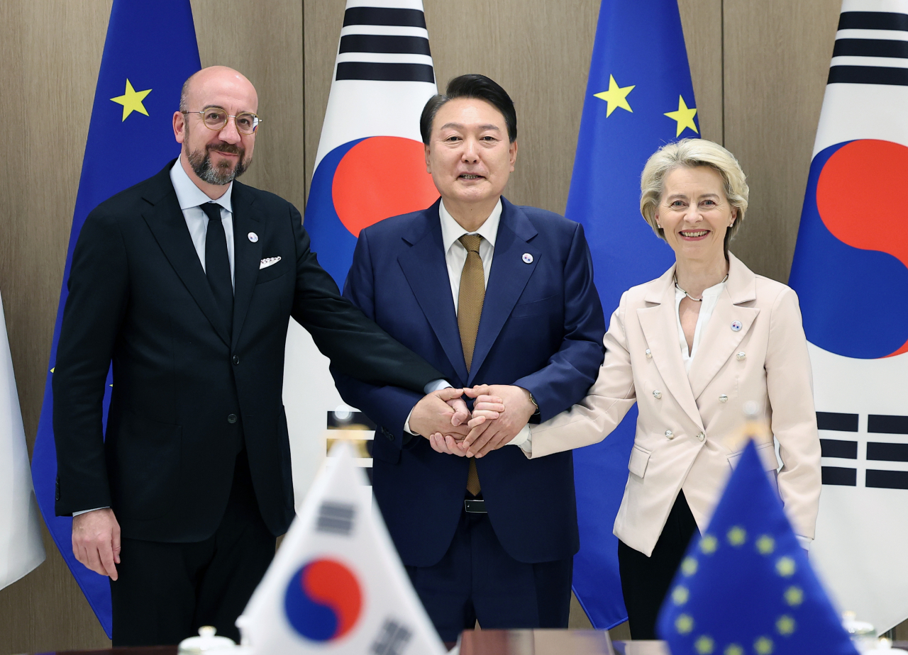 President Yoon Suk Yeol (center) shakes hands with European Commission President Ursula von der Leyen and European Council President Charles Michel at the summit held in Seoul on Monday. (Yonhap)