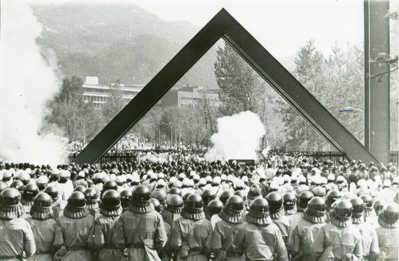 Student protesters at Seoul National University face off with the police in front of the university's front gate in Gwanak-gu, southern Seoul, in this May 7, 1986 file photo. (Herald DB) (Courtesy of the Korea Democracy Foundation)