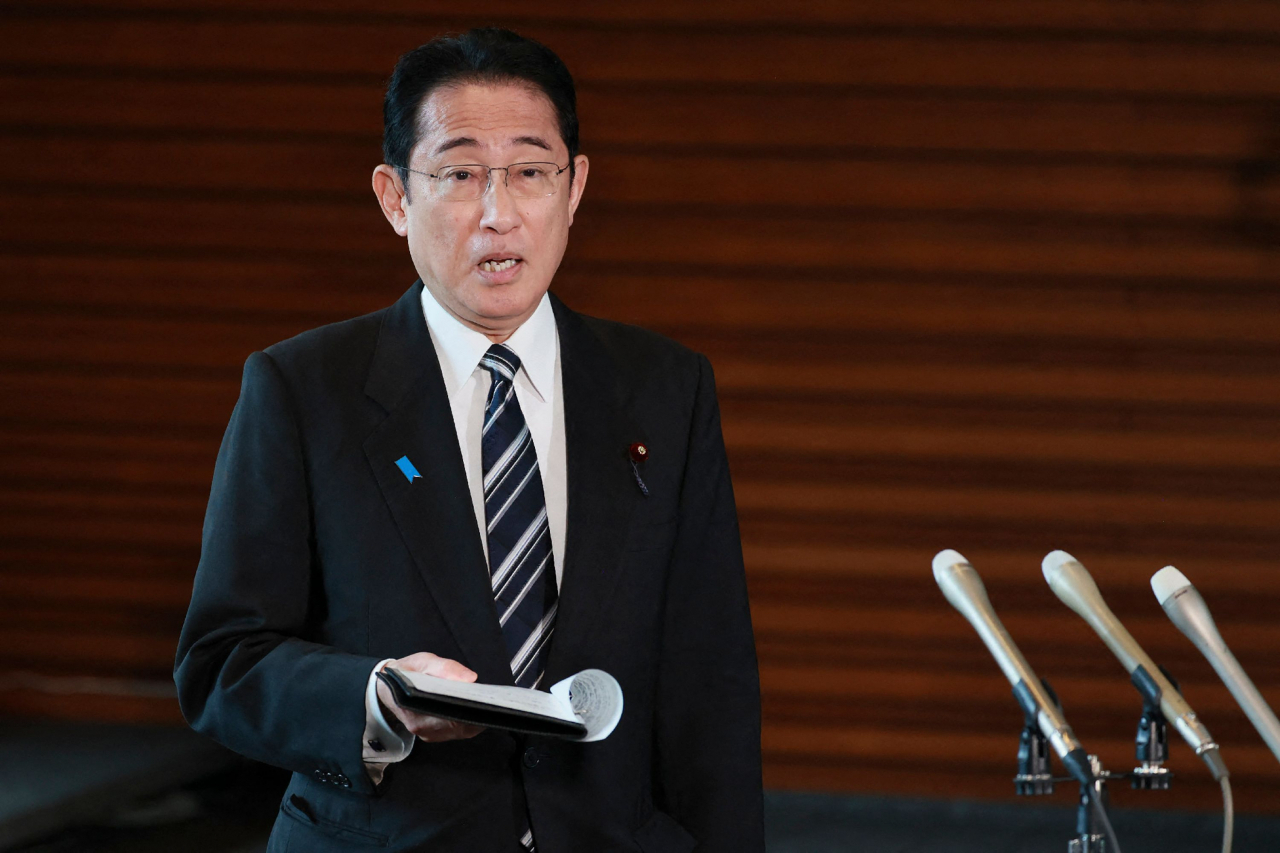 Japanese PM Fumio Kishida answers questions from reporters after North Korea announced it would launch a satellite at his office in Tokyo on Monday. (AFP)