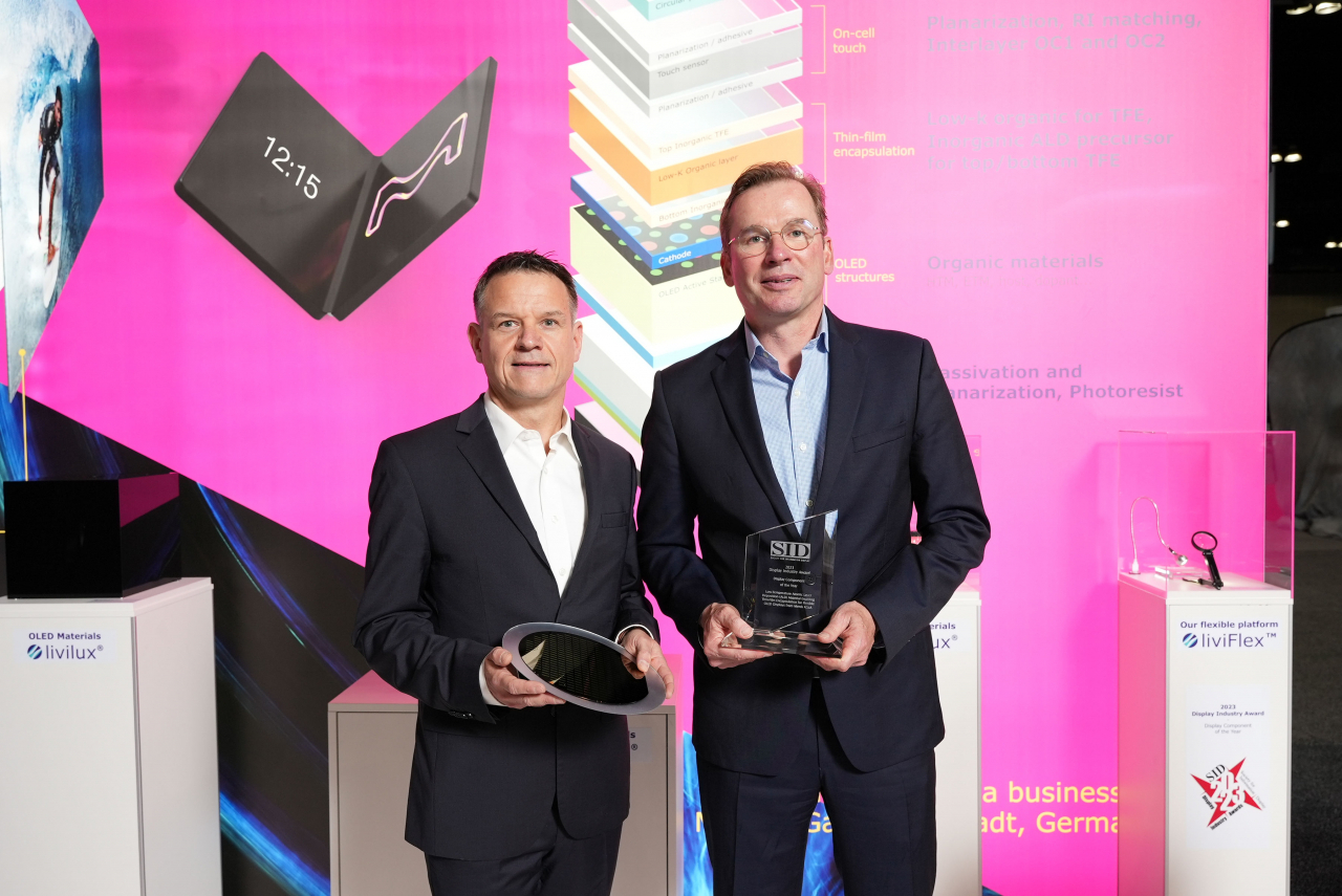 Damien Tuleu (right), the head of Display Solution Business at Merck, poses during the Display Component of the Year 2023 Award that was hosted by the Society for Information Display in Los Angeles earlier this month. (Merck)
