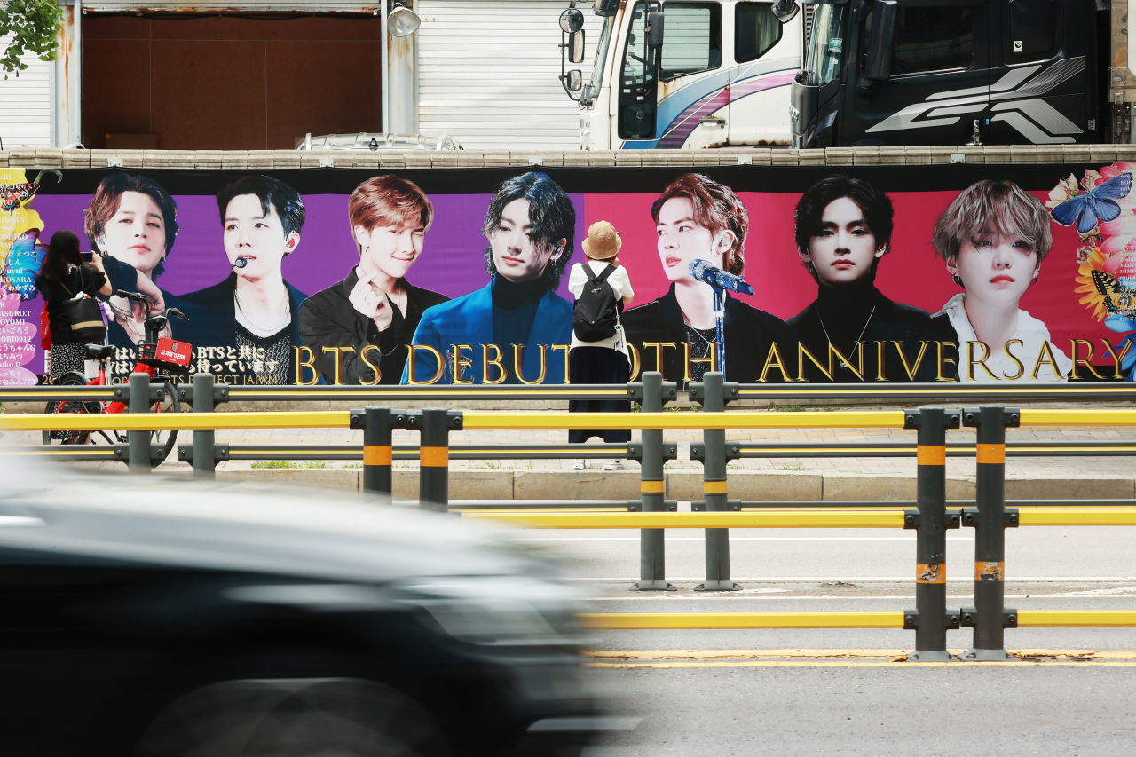 A wall near Hybe's headquarters in Yongsan-gu, Seoul, is decorated with pictures of BTS members and a message celebrating the group's 10th anniversary on Monday. (Yonhap)