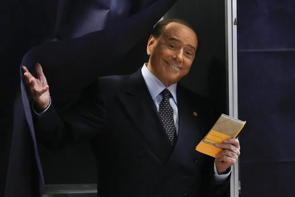 Silvio Berlusconi comes out of a voting booth before casting his ballot at a polling station in Milan, Italy, Sept. 25, 2022. Berlusconi, the boastful billionaire media mogul who was Italy's longest-serving premier despite scandals over his sex-fueled parties and allegations of corruption, died, according to Italian media. He was 86. (AP Photo/Antonio Calanni, File )