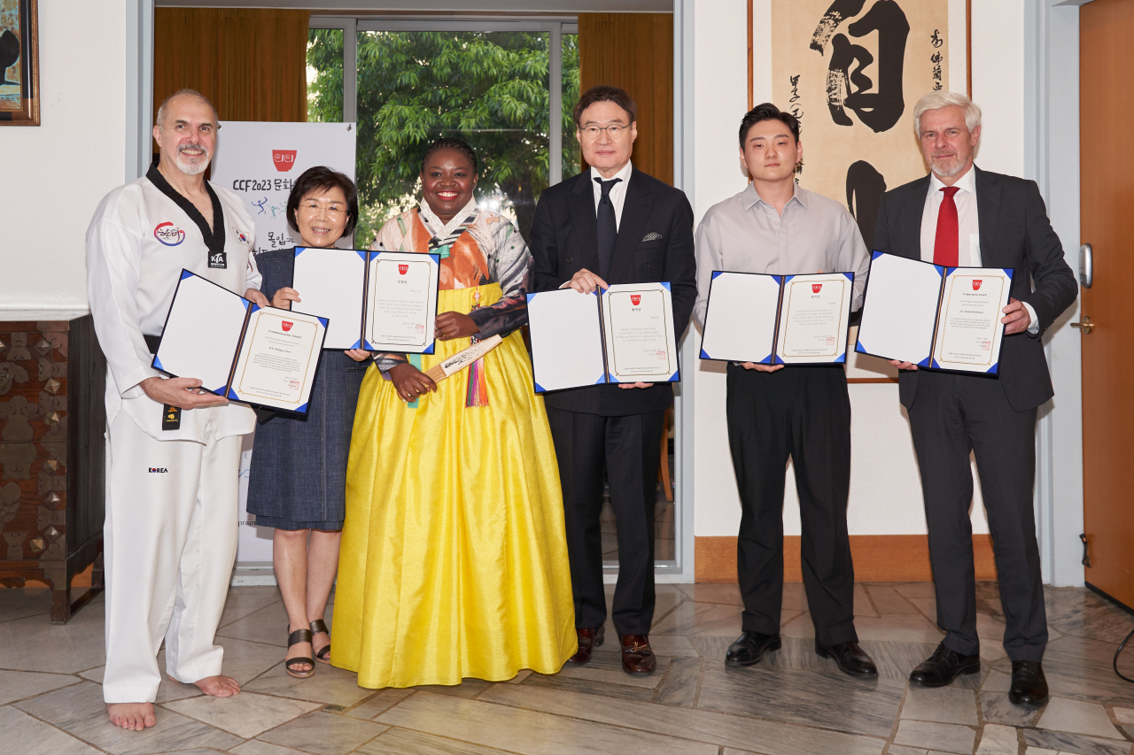 (From left) French Ambassador Philippe Lefort, CICI President Choi Jung-wha, pansori singer Laure Mafo, Chairman Eugene Bang of Millenasia, magician Ed Kwon and German Ambassador Michael Reiffenstuel pose for a group photo after the award ceremony during CCF 2023, held at the French ambassador's residence, Tuesday. (CICI)