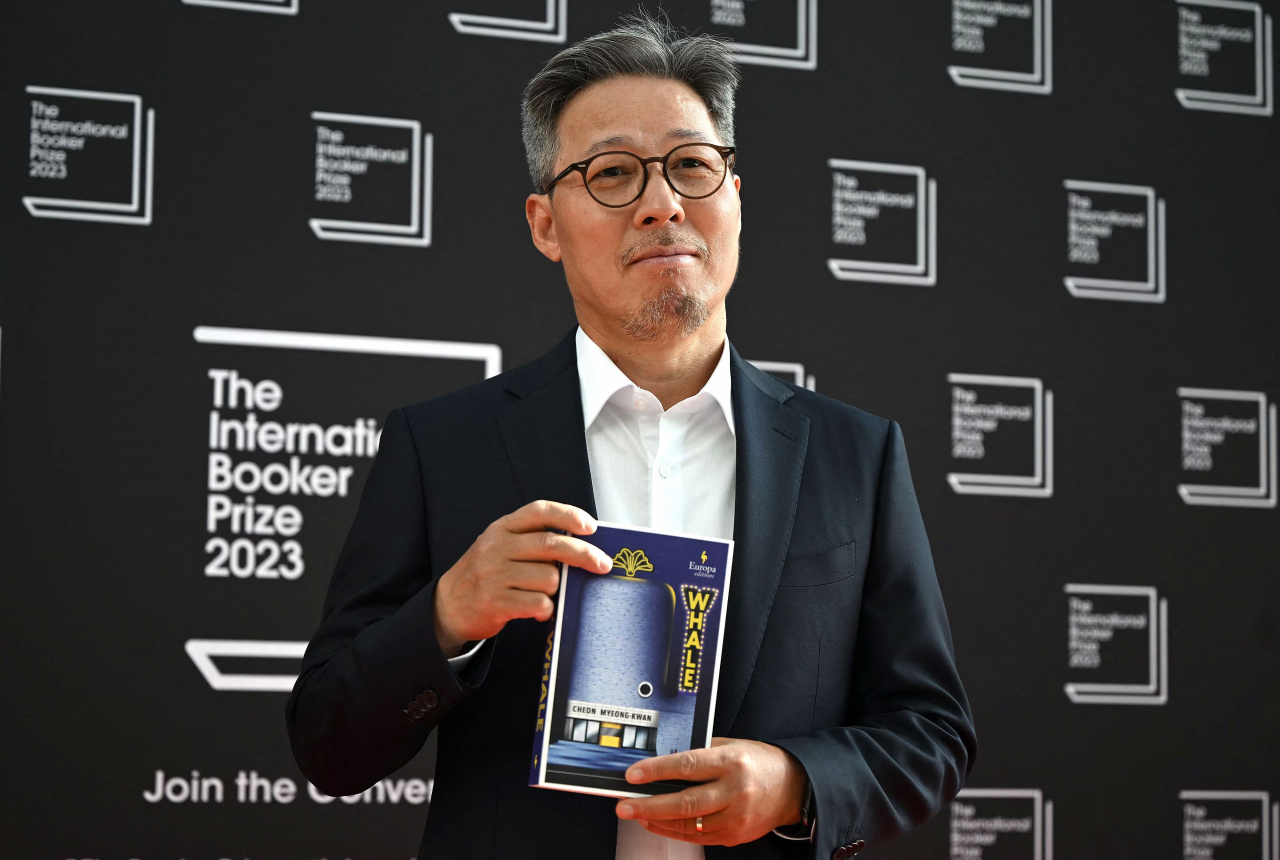 South Korean author Cheon Myeong-kwan poses with his book 