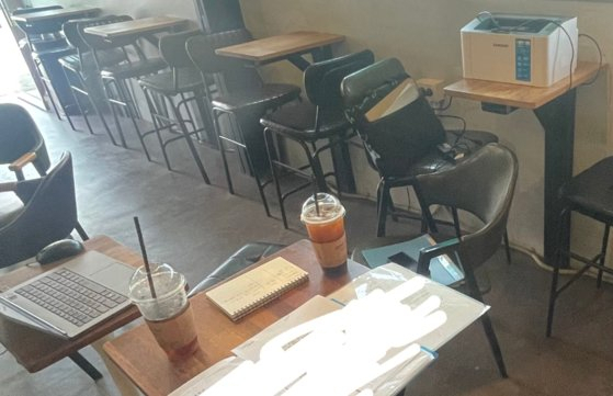 A printer is set up on a table at a cafe in this photo shared by a cafe owner who claimed that 