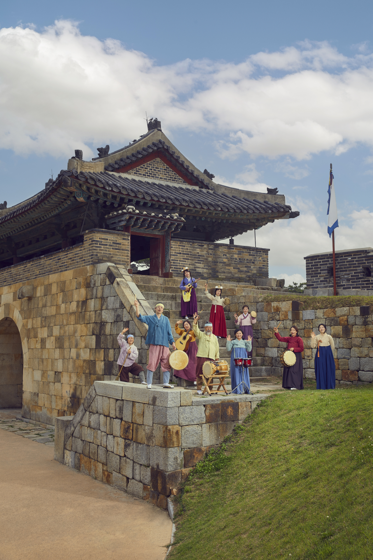 2023 World Heritage Festival staff pose next to the Suwon Hwaseong Fortress in Suwon, Gyeonggi Province. (CHA)