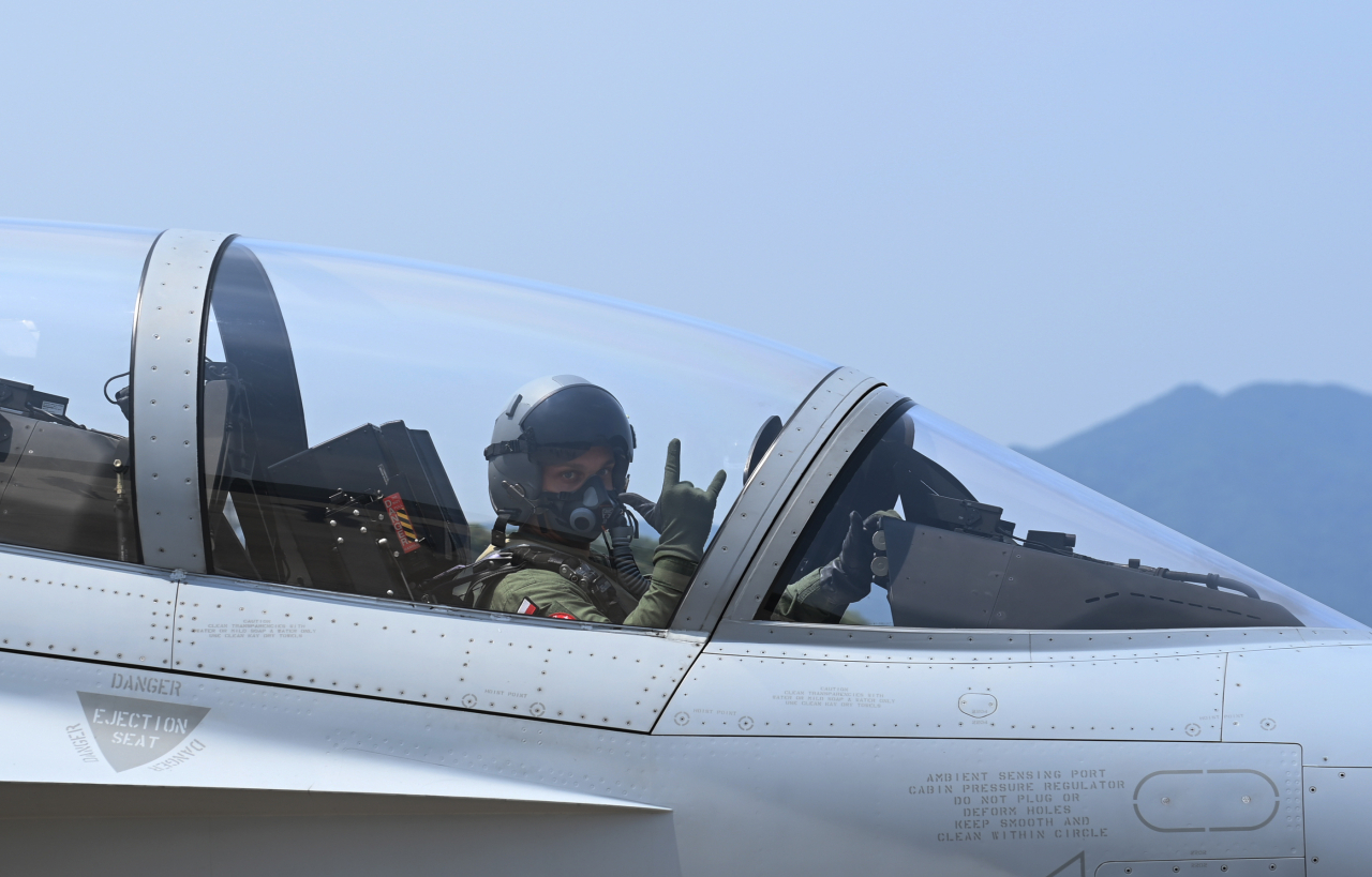Capt. Sebastian Rajchel of the Polish Air Force gestures before takeoff while boarding the TA-50 aircraft at the South Korean Air Force's 16th Fighter Wing in Yecheon County, North Gyeongsang Province, on Monday. (Republic of Korea Air Force)