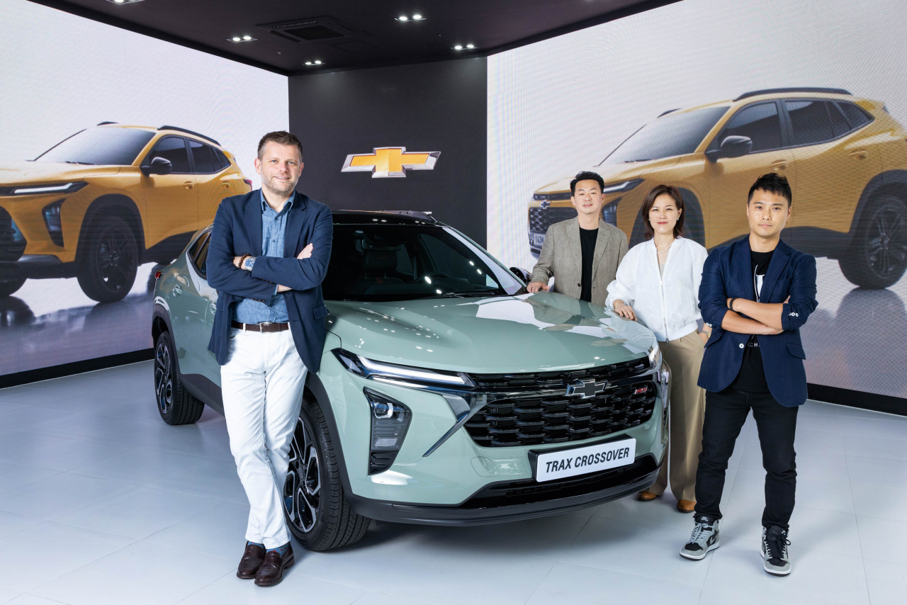 (From left) Stuart Norris, design vice president of GM China and GM International, and designers at GM design studio in Korea -- Lee Hwa-soup, Whang Bo-young and Kim Hong-ki -- stand next to the Chevrolet Trax Crossover during an interview at the House of GM in Seoul on Tuesday. (General Motors)