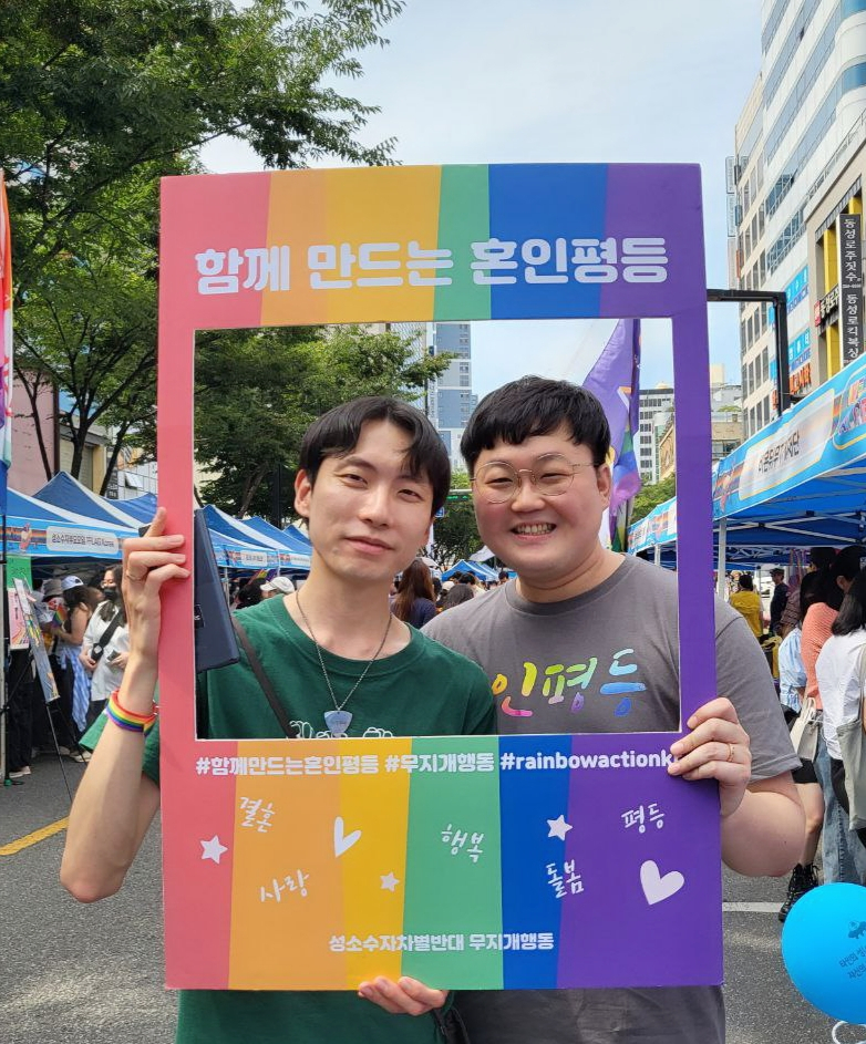 So Sung-uk (right) and Kim Yong-min pose for picture at the Seoul Pride Parade last year. (Courtesy of Kim Yong-min)