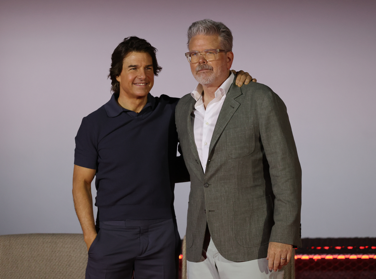 Tom Cruise (left) and director Christopher McQuarrie pose for a photo during a press conference held as part of the promotional world tour for “Mission: Impossible – Dead Reckoning Part One” at Lotte Cinema World Tower in Seoul, Thursday. (Yonhap)