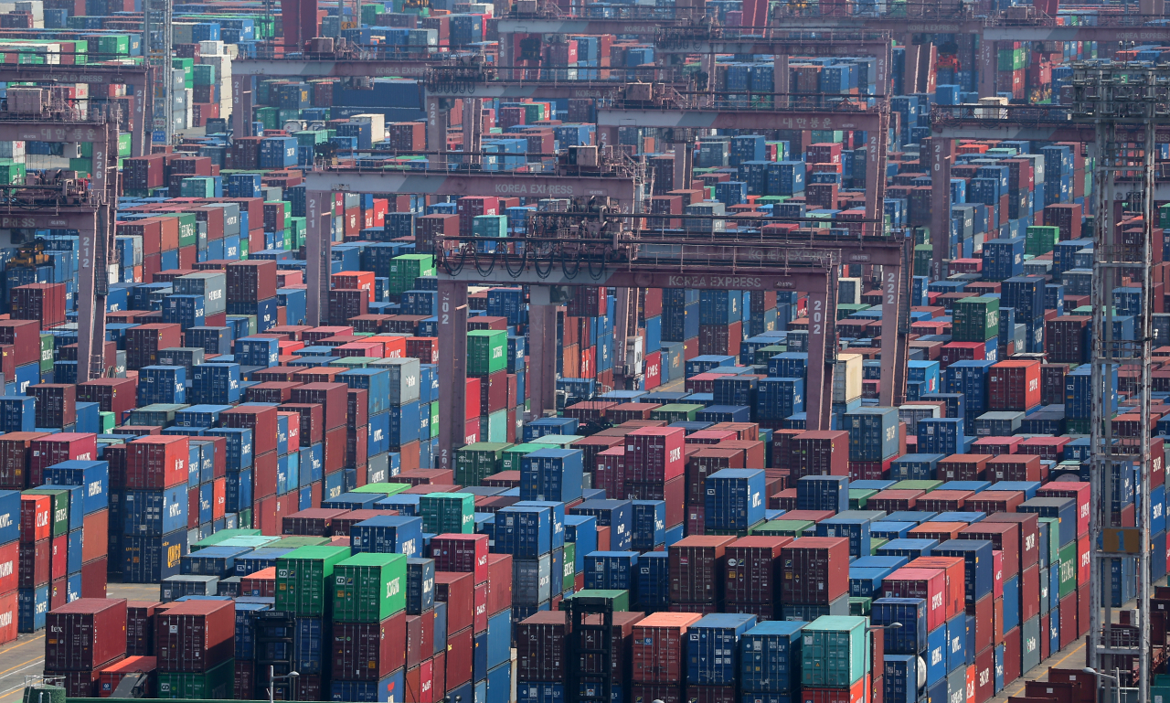 Containers for exports and imports are stacked at a pier in Busan, country's largest port city, Sunday. (Yonhap)