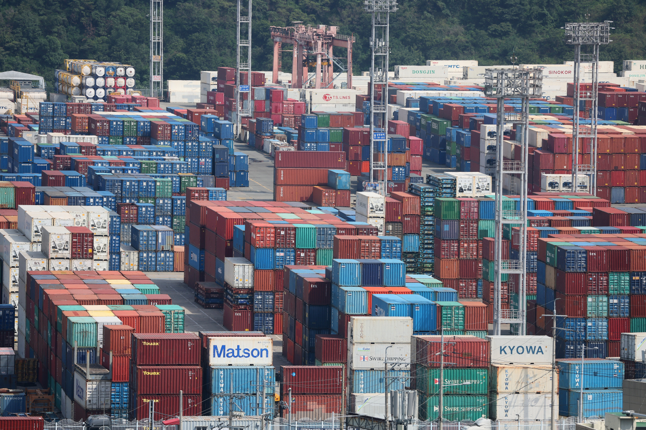 Containers are stacked at a pier in South Korea's largest port city of Busan on Sunday. (Yonhap)