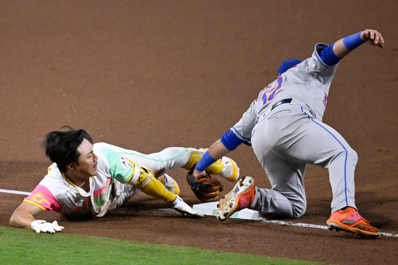 Kim Ha-seong of the San Diego Padres (left) is tagged out at third base by Luis Guillorme of the New York Mets during the bottom of the seventh inning of a Major League Baseball regular season game at Petco Park in San Diego on Friday. (Yonhap)