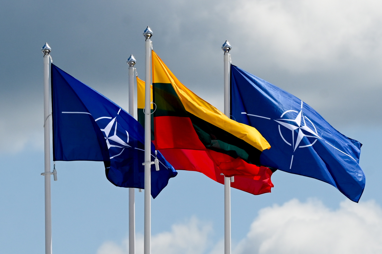 The NATO and Lithuanian flags are seen at the summit venue in Vilnius, Lithuania, on Sunday. EPA/FILIP SINGER