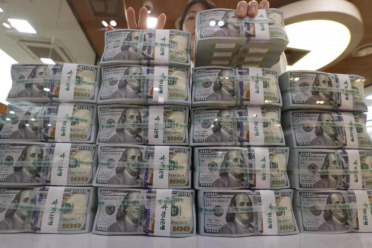 $100 banknotes stacked at the headquarters of Hana Bank in Seoul on July 5 (Yonhap)