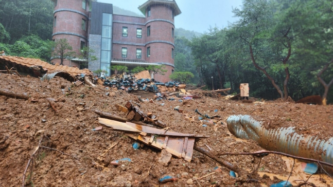 Yangji Memorial House in Nonsan, South Chungcheong Province, is seen buried in mud and debris after a landslide. (South Chungcheong Fire Department)