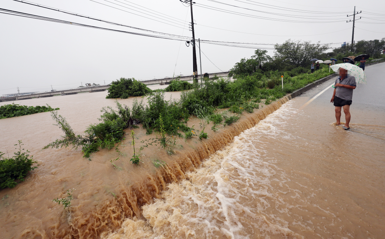 A road in Cheongju is flooded due to torrential rain on Saturday (Yonhap)