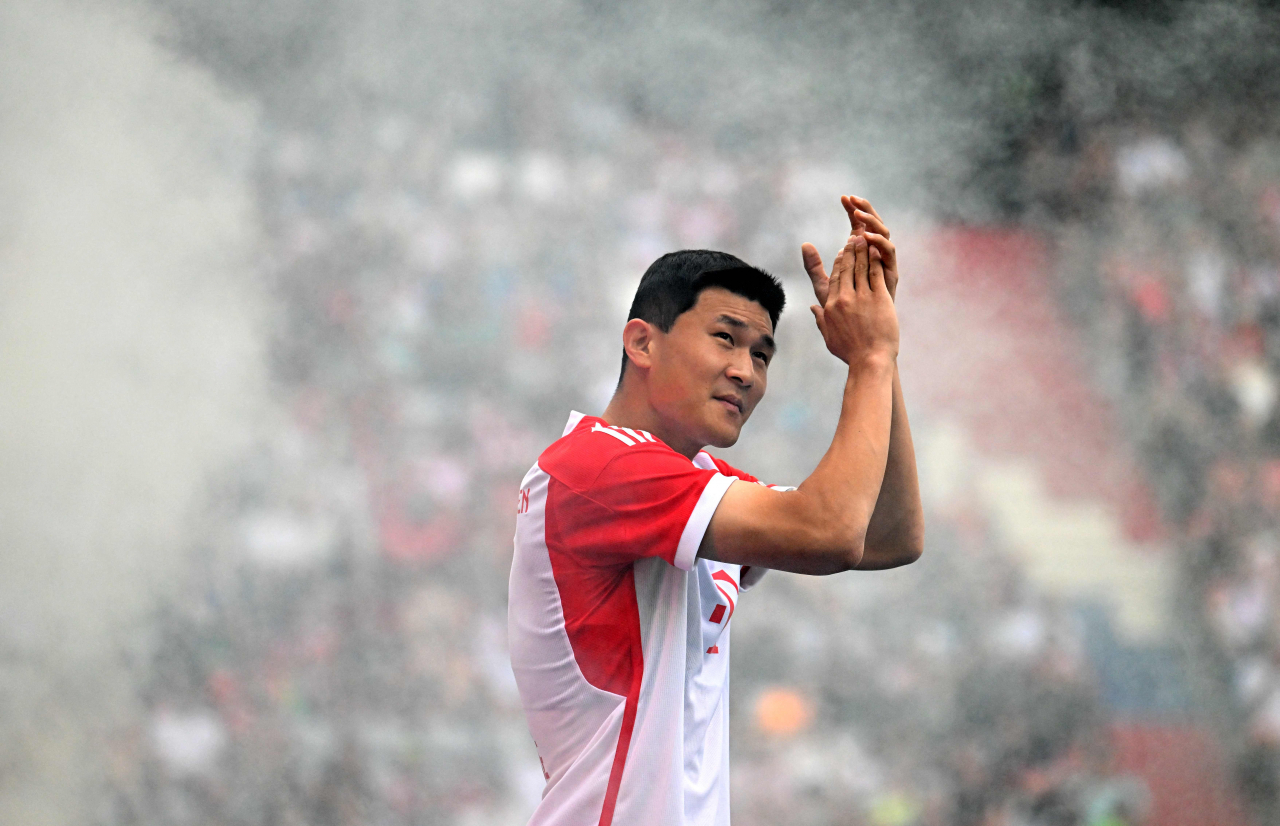 Bayern Munich's new South Korean defender Kim Min-jae applauds the fans during the team presentation of the German first division Bundesliga club Bayern Munich in the stadium in Munich, southern Germany, on Sunday (AFP)