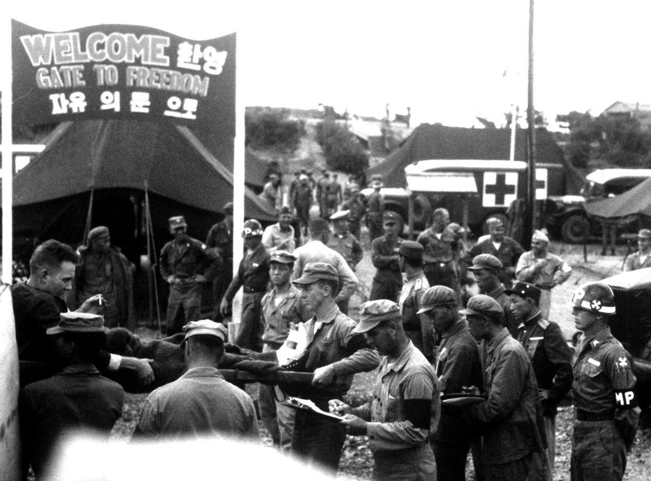 North Korean forces turn over prisoners of war to the UN authorities at the POW receiving center at Panmunjom on the inter-Korean border in the process of repatriation. (Date unknown, US Air Force)