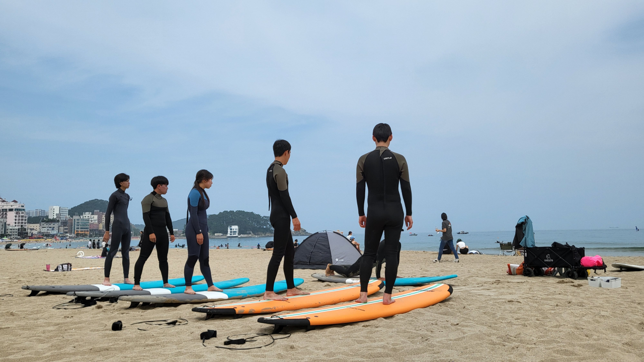 Surfers take lessons from an instructor on Ilgwang Beach in Gijang-gun, Busan. (Kim Hae-yeon/ The Korea Herald)