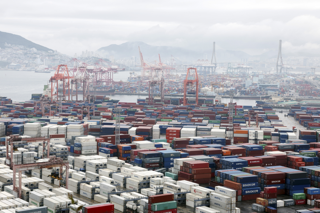 Containers for exports and imports are stacked at a pier in Busan, country's largest port city. (Yonhap)