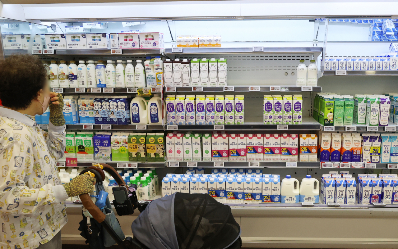 A customer shops for milk at a large discount store in Seoul on Thursday. (Yonhap)