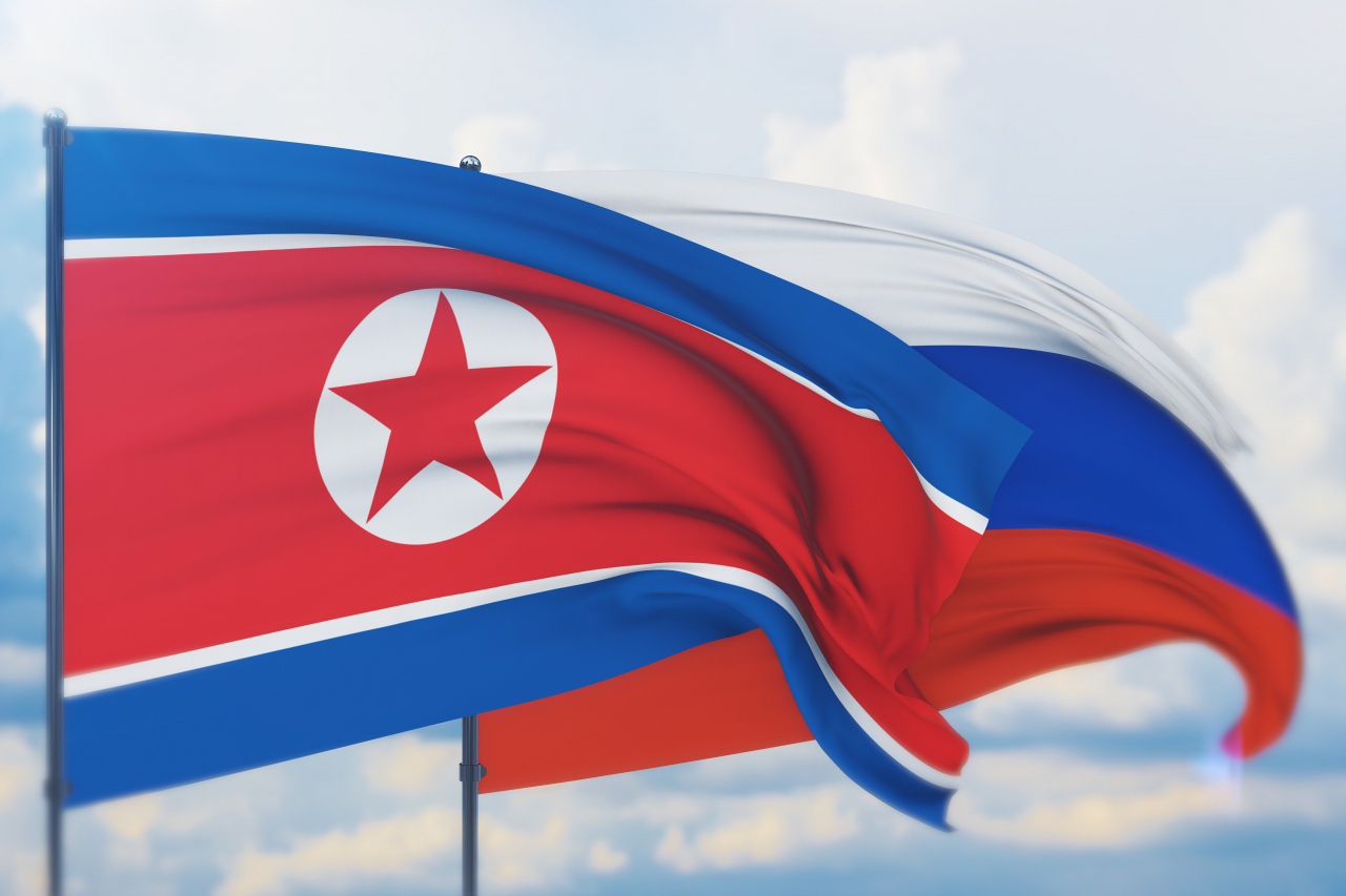 The North Korean flag (left) and Russian flag. (123rf)