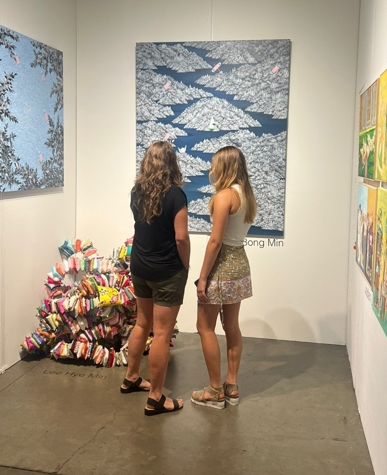 Visitors to the seventh Seattle Art Fair that ended Sunday take a look at works displayed at the booth of Sanji Gallery (Courtesy of the gallery)