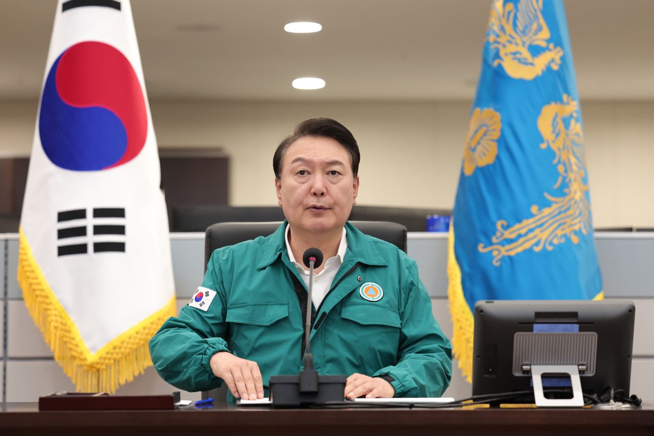 President Yoon Suk Yeol presides over an emergency meeting on the response to Typhoon Khanun at the presidential office building in Seoul on Tuesday. (Presidential office)