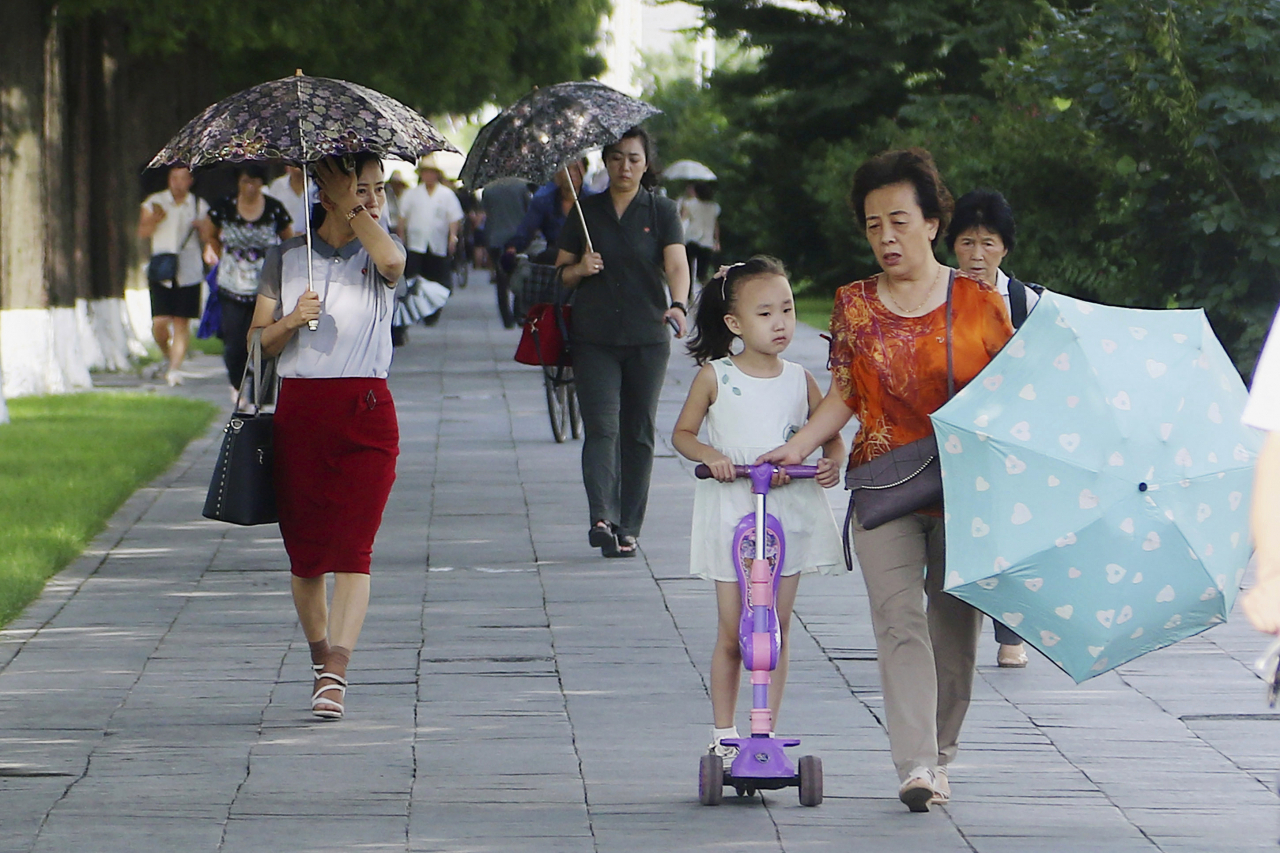 People walk on Ryomyong Street in Pyongyang, North Korea, on Tuesday. (Photo - AP)