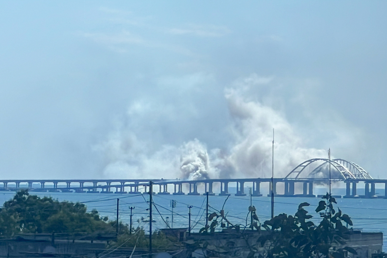 Smoke is seen by Crimean Bridge on Saturday. The Russian Defence Ministry reports to have intercepted a Ukrainian modified S-200 missile guided to attack Crimean Bridge. (TASS-Yonhap)