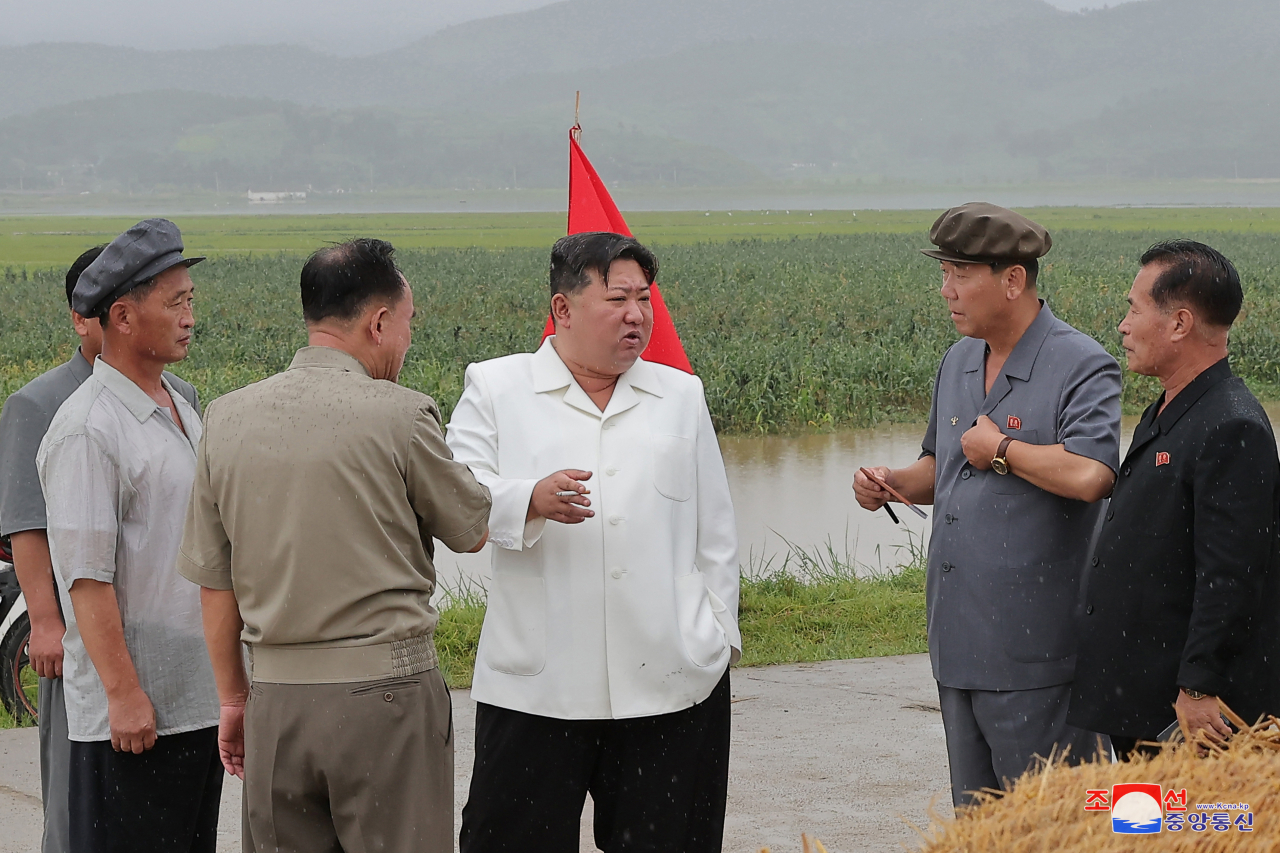 This photo from Sunday shows North Korean leader Kim Jong-un (center) visiting Anbyon County, Kangwon Province, which suffered damage from Typhoon Khanun. (KCNA)