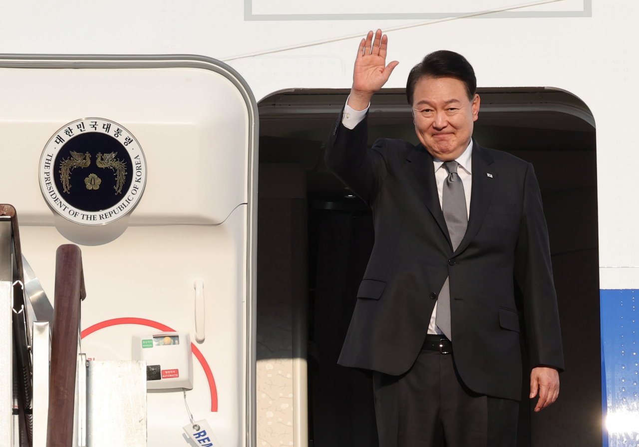 President Yoon Suk Yeol waves as he boarded Air Force One at Seoul Air Base in Seongnam, Gyeonggi Province, Thursday. Yonhap