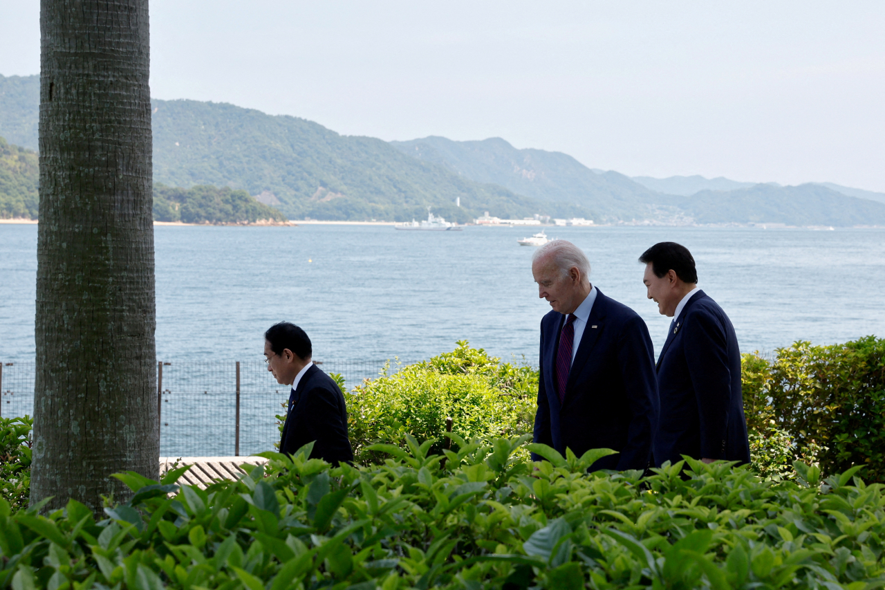 US President Joe Biden walks with Japan's Prime Minister Fumio Kishida and South Korea's President Yoon Suk Yeol on the day of trilateral engagement during the G7 Summit at the Grand Prince Hotel in Hiroshima, Japan. (Reuters-Yonhap)
