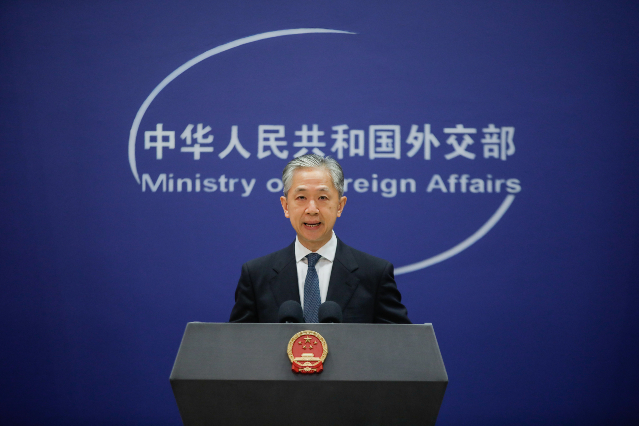 China's Foreign Ministry spokesperson Wang Wenbin gestures during a press conference at the Ministry of Foreign Affairs in Beijing, China. (EPA-Yonhap)