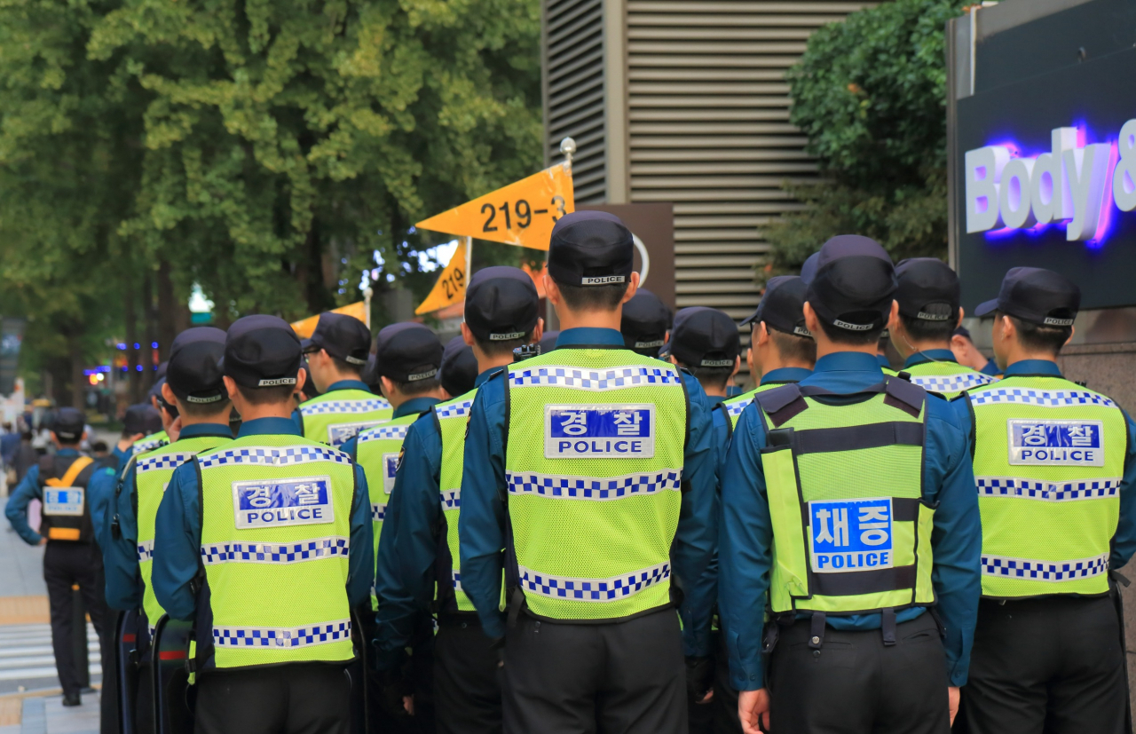 A group of conscripted police officers march along a street in Seoul. (123rf)