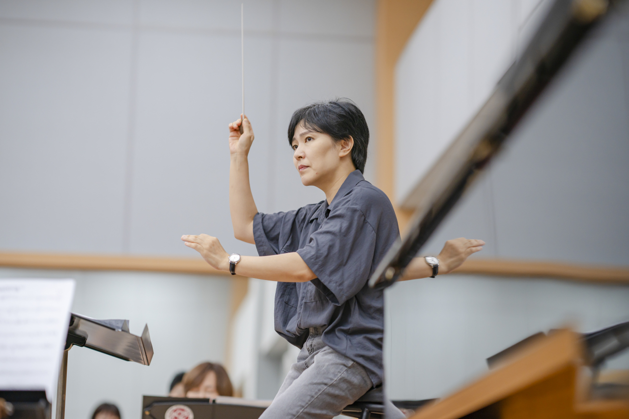 Conductor Year Ja-kyung conducts in a rehearsal for 