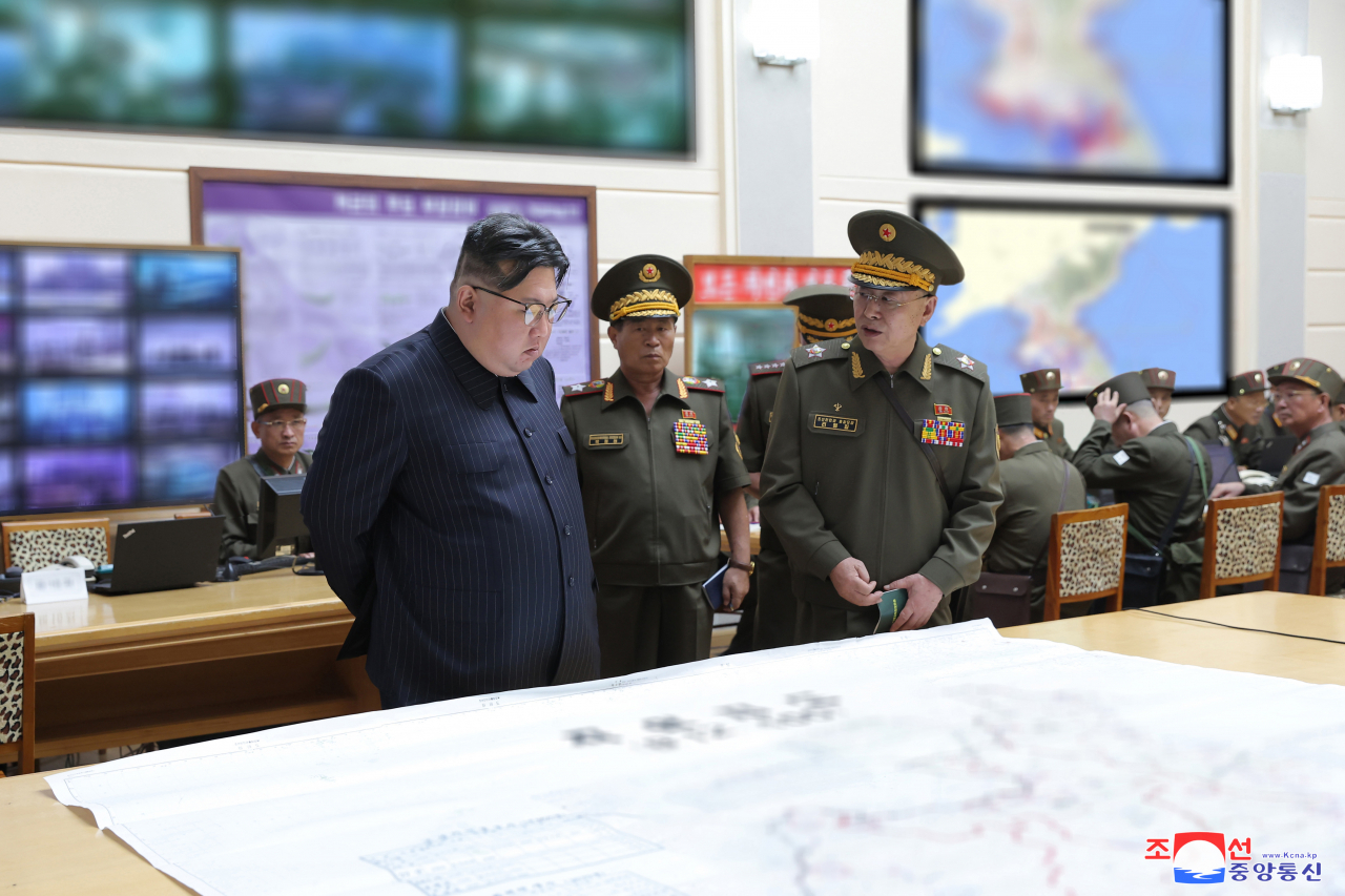 This photo, published by North Korea's Korean Central News Agency on Aug. 31, 2023, shows the North's leader, Kim Jong-un, (front left) visiting the training command post of the General Staff of the Korean People's Army as the country conducted military command drills involving the entire army on Tuesday. (Yonhap)