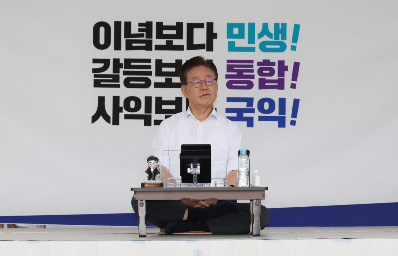 Democratic Party of Korea leader Rep. Lee Jae-myung sits inside a tent installed outside the National Assembly building on Thursday, as he stages an indefinite hunger strike in protest against the Yoon Suk Yeol administration. (Yonhap)
