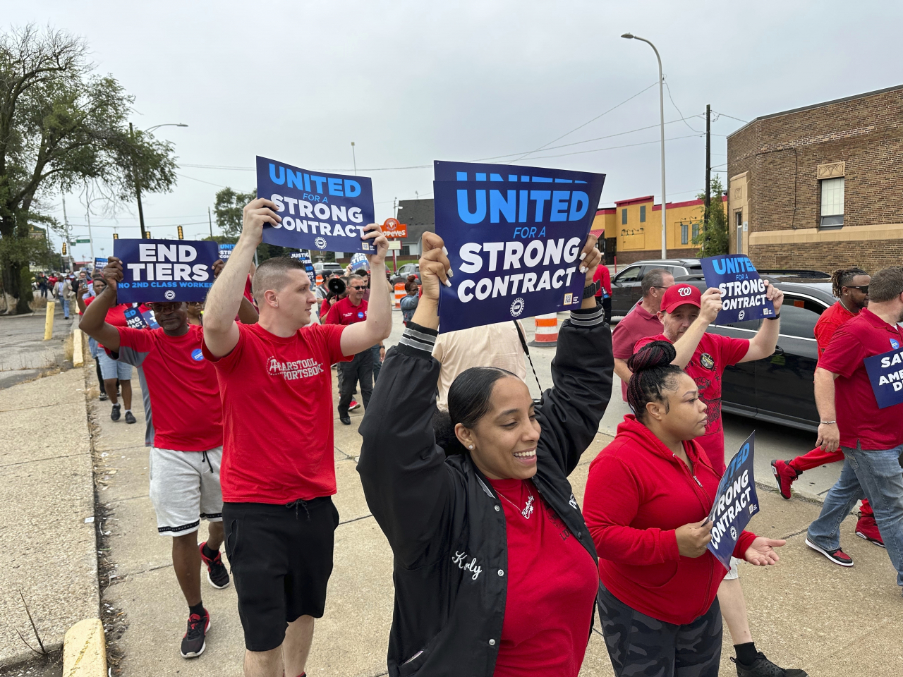 United Auto Workers members march holding signs at a union protest held near a Stellantis factory in Detroit on Aug. 23. (AP)