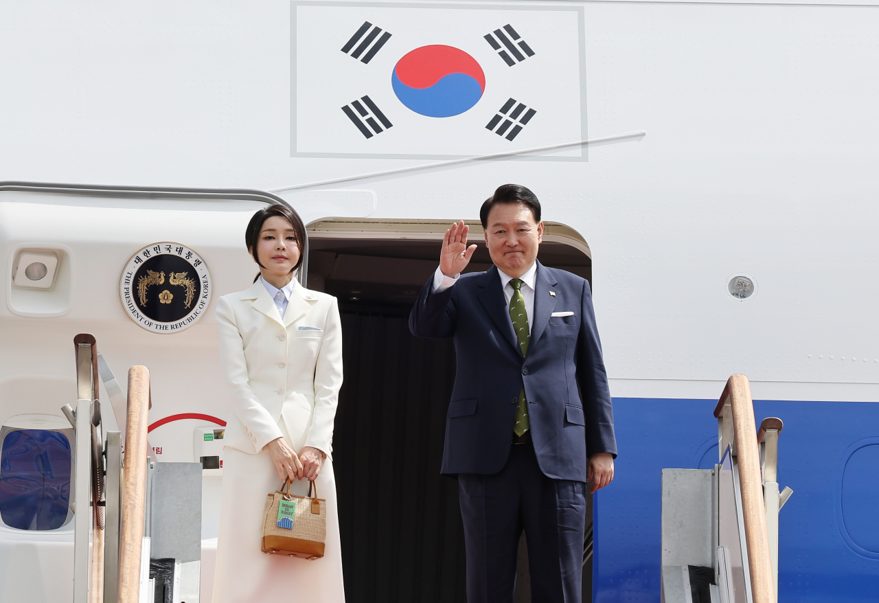 President Yoon Suk Yeol and first lady Kim Keon Hee, who will visit Indonesia and India to attend the ASEAN summit and the G-20 summit, depart from Seoul Air Base in Seongnam, Gyeonggi Province, on Tuesday. (Yonhap)