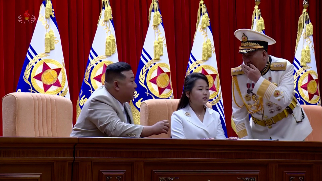 This image, captured from footage of North Korea's state-run Korean Central Television on Aug. 29, shows North Korean leader Kim Jong-un (left) and his daughter, Ju-ae, visiting the country's naval command two days earlier to celebrate Navy Day, which fell on Aug. 28. (Yonhap)