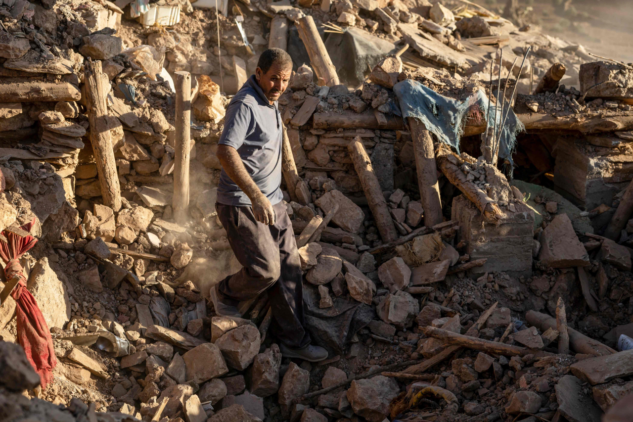 A villager searches for survivors amidst the rubble after an earthquake in the mountain village of Tafeghaghte, southwest of the city of Marrakesh, Saturday. (AFP-Yonhap)